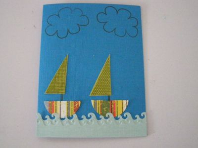 A boat card
I used the clouds and parts of the kite as boat sails.  To cut out the bottom of th boat I used my Fiskars wave squeeze punch.  I used the boundary waters Fiskar border punch also. TFL
