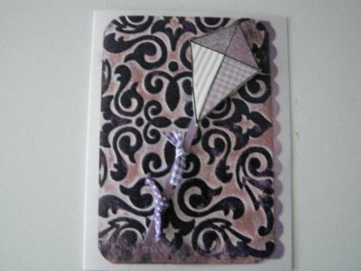 Kite card
I dry embossed the background with a Sizzix embossing folder and then used Dusty Concord distress ink over the top and while it was wet I heat embossed it with clear embossing powder. When that was dry I distressed it with Victorian Velvet also.  I used ribbons as the kite tails. TFL!!
