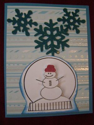 A snow globe card
I used my Making Memories Slice to cut out some snowflakes for the top of the card.  I paper pieced the snowman's hat.
