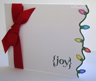 {joy}
It's very hard to tell from this picture, but the lights were stamped in black, colored with Prismas, and then trimmed so that they make a border that reveals the back of the card.
