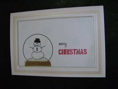 It's hard to see all the glitter on this card but there's plenty of it. I used diamond glitter glue for the snow around the base of the snowman. And on this one I cut a shimmery red & gold textured ribbon to cover the base of the snowglobe. 
