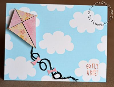 Go Fly a Kite!
I made the paper in Photoshop using the cloud digital brush. I used the triangle brushes to make clipping masks for paper from Traci Reed's digital kit Wish on a Rainbow (I shrunk the flower paper so the scale would work with the triangle sizes I was using.
