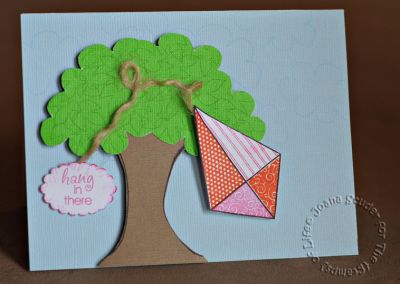 Hang In There
I used the larger cloud to design the tree top. The tree trunk was made with the balloon string from HappyBday2You. The tree leaves are from Thanks2Fall, and the Hang in There sentiment is from Banners4all.

If you look closely, you can see clouds stamped in a light baby blue.
