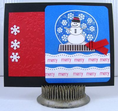 Merry Snowglobe Card
Fun card using the November Joy2Christmas set.  I embossed the snowglobe and snowflakes with white embossing powder.  Rubbed some clear Stickles between the snowflakes which gives it some "shine."  :)  The mounds of "snow" at the bottom are a border punch by EK Success.  The  snowflakes embossing folder is by Sizzix.
