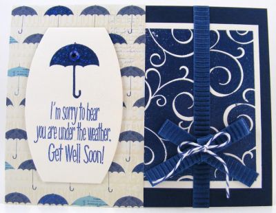 *Under The Weather Card*
I heat embossed the swirls4background with Clearsnap's Mix'd Media Inx Embossing Powder in Denim.  The umbrella from umbrella4you is also heat embossed. (Sentiment is from umbrella4you too.)  The diecut is Sizzix (#658204 Labels, Ornate #3).
Keywords: swirls4background