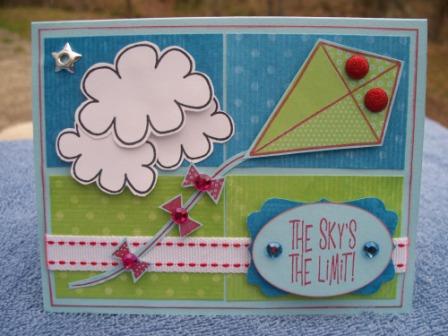The Sky's The Limit
This was a challenge for an online crop.  The Challenge was 5, 4, 3. 2, 1.  5 Embellishments, 4 Patterned Papers, 3 Stamps, 2 Punches, 1 Cardstock.  Materials used:  Paper from The Paper Studio, ColorBok, Ribbon from Stampin Up!, punches from EK Success, embellies were in my stash.  I used the stem from Daisies4You for the kite tail.  
Instructions from below continued:  Cut out clouds, kite, kite tail, kite bows.  Punch out sentiment and mat for sentiment.  Assemble, adhere, add embellies.

http://kellyisascrapdiva.blogspot.com
