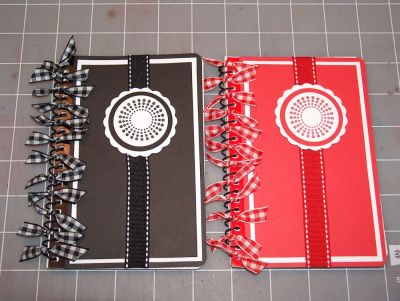 Small Memo Notebooks
I got this idea from an online tutorial.  These are small memo notebooks from Walmart.  They only cost .94 cents each.  I just covered the front with some matted cardstock and added ribbon and one of the back2basics stamps.  I used a scallop cut from my cricut, and to punches for the center decoration.
Keywords: Small Memo Notebooks