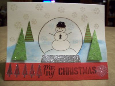 Merry Christmas
I used the Joy2Christmas Nov. 09 Clear Stamps. I love the snowman and globe. It is so much fun using the stamps that Stephanie has designed.  I used glue and glitter on the hat and base of the globe and also on the big trees and on the border. I Also used water color pencils and brush to do the snow. 
Keywords: Joy2Christmas Nov.09 Clear Stamps