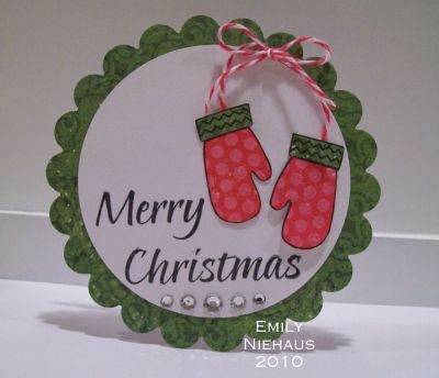 Christmas Mittens...
I made this scallop circle card using my nesties.  I covered the front with DP from Echo Park's Everybody Loves Christmas collection.  I paper pieced the mittens using the same paper.  I added some Baker's Twine to hold my mittens together and some rhinestones at the bottom.

TFL!

http://emmielouwho.blogspot.com/
Keywords: Christmas2build Christmas