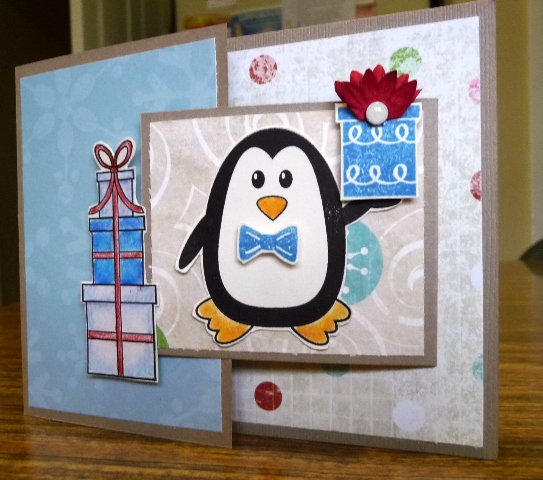 Joy Fold Card
I used foam tape to pop the presents up a little so that the "flap" section the penguin is on would set underneath to hold shut. The fluffy bow on top of the present he is holding is a prima flower folded in half & trimmed a little
