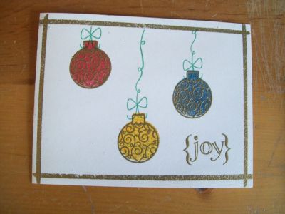 Joy
I drew a line border with the Versa Marker and embossed with gold powder.  I also embossed over the baubles with the detailed stamp.
