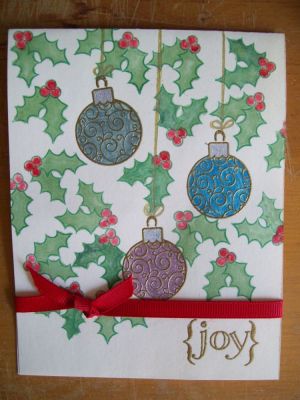 Holly and Baubles
I embossed the baubles with gold powder then used my Sakura metallic pens to colour them in.  I stamped and coloured in the holly with Copic markers, (where is the solid holly leaf when I need it?).  I added a red ribbon and stamped the JOY sentiment.
