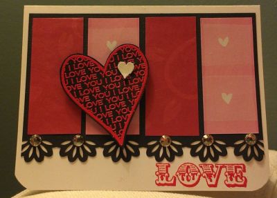 LOVE
I love the way this turned out. The card itself is white, so as you can see the colours in real life are much different! I stamped and used red embossing powder on black cardstock, I also used red embossing powder on the LOVE stamp. I picked up a border punch that I used on the black background piece, and added a little bling. The white heart is embossed and cut out. I used a corner rounder for the 2 bottom corners.
