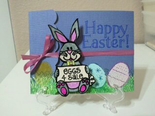 Eggs for Sale
DCWV matchbook card that was heat embossed with the grass from bunny4Easter set and the Eggs4Easter sets.  Eggs heat embossed with ZING powder. Bunny stamped on white paper, colored with Bic markers, then outlined with Sakura (black) Glaze pen, fussy cut and attached with Action Wobble. Ribbon secured with tiny clear adhesive dots (Zots).  
Keywords: Easter eggs bunny