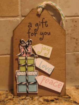 The "Real Gift" of the Season
I used archival black ink to stamp the gifts so they wouldn't bleed, when coloured with markers. Glossy Accents was used to secure the baker's twine to the shaped bow.
