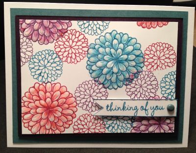 Mums For Fall
 After stamping the mums onto white cardstock, I wanted to see if I could color them using the 3rd set of ink pads as my 'coloring' tool.  I had one of the storage sheets sitting on my table, so I rubbed some of the ink from 3 of the ink pads onto the sheet.  Using a blender pen, I picked up some of the ink and feathered in the corresponding color onto each of the large mums.  Once that was done, I used some glossy accents on each of the petals to give them more dimension...it kind of looks like rain drops.
Keywords: Mums. Fall