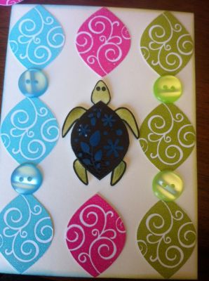 heat embossed all the turtle shells in different colors cut them out. Placed one single turtle in the middle. Added buttons to cover the spaces between shells.
