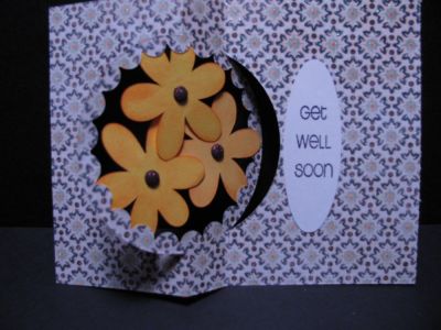 blackeyed susan inside
just love using up pattern paper.

The circle was cut out using nestabilities, three flowers were cut out and sponged with tangerine, the centers are glittery-brown sticky buttons.  They are affixed with stick glue and the oval has GET WELL SOON from Trees2build.  

The flowers that are here can be made with the Daisies4You.
