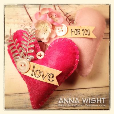 Felt Hearts
Felt Hearts made with the Sizzix heart die/stamp set. 
Die cut the felt using the large heart die in the set, stitch two hearts together and lightly stuff before closing up your edge stitches. Embellish!
