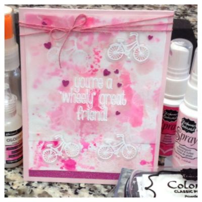 Used TSOL guava & bubblegum ink sprays and the powdered sugar ink pad for the small bicycle stamps on the background.  I heat embossed the sentiment with white embossing powder.
