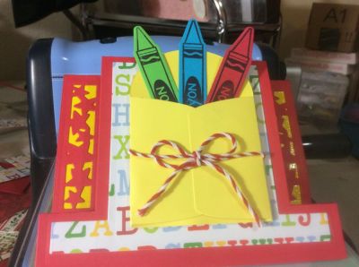 Also used the crayons 2 stamp and card holder die. Happy accident, I wanted yellow as a background for the stars and used paper with sizzix adhesive on it.  It just left the background sticky so I put some embossing powder on and now it looks like enamel.
