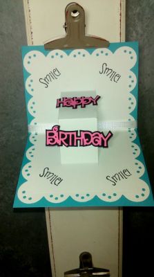 inside of previous card Happy Birthday 
I used the sizzix greetings scalloped edge to cut the white paper, then folded that in half. I placed a rectangular die from the box card dies in the center. I turned this in the sizzix big shot up til the edge of the die creating the pop out look. 
