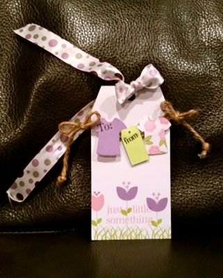 "Just a little something"
I made a cute clothesline gift tag with the t-shirts hanging that say 'to' and 'from' 
ribbon is longer to attach to a gift bag 
