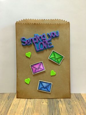 Treat Bag
A 5x7 kraft treat bag adorned with glittery mini envelopes.
