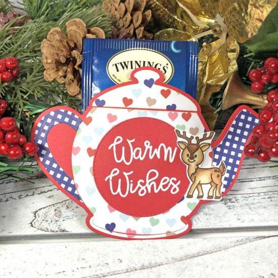 Tea Bag Holder
A tea bag holder is a perfect gift idea for a friend, co-worker, teacher, or loved one. I used the Tea Pot Fold-it die set from The Stamps of Life. These tea bag holders have a bag of holiday tea and a honey packet inside. To see how I made these, watch my video tutorial.
