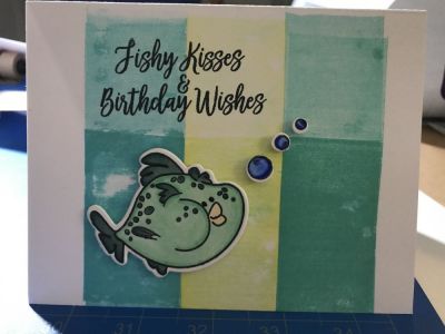 Fishey Birthday Card
A2 card using largest fish and bubbles colored and blended with spectrum noir markers. Bubbles had sparkle added to them using spectrum noir clear sparkle marker over blue color. Base of car was inked using 3 different Ranger Archvical ink in Teal, Bannana, and Blue utilizing a brayer. Fish and bubbles were cut out using accompanying die cuts from stamp and die cut club set and then adhered using Scotch foam tape. Sentiment was used from the fish2stamp "fishy kisses & birthday wishes" in black memento ink.
Keywords: Fish2stamp largest fish bubbles 