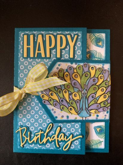 Peacock Birthday
Fold Over Card front - created coordinating patterned paper with feather stamp and peacock stencil 4 to color random dotted paper in matching colors 
Keywords: OriginalFoldOverCard
