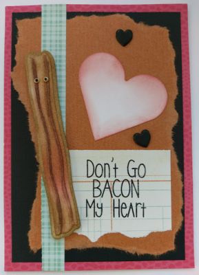 One strip of bacon says not to go bacon his heart
Don't go bacon my heart stamped in black ink is cleverly put on this half ripped notebook paper. Only ONE of the bacon strips is needed to die cut and color in. I added a couple of black heart brads floating around a much larger red heart in the background. 
Keywords: bacon love