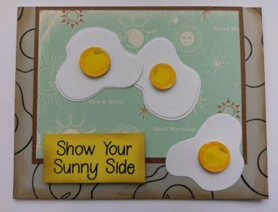Show your sunny side
Three eggs show their sunny side on grey egg stamped background paper. When you don't have the perfect paper available, make your own with your stamps. One of the eggs does not have the white egg cutout behind it like the other two eggs do and shows you the difference between the two looks you can get with your cutting dies from this set.
Keywords: eggs