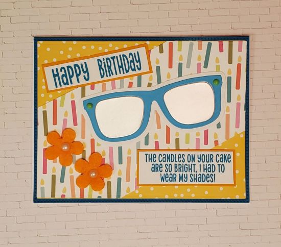Birthday Shades
What a fun Birthday card using the Sunglasses. Love this sentiment. Silver reflective paper for the lenses and orange felt flowers to tie it all together.
Keywords: Sunglasses Shades
