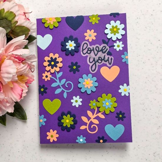 Using cut "left over" cut out pieces from other cards to create a layered floral card front.
