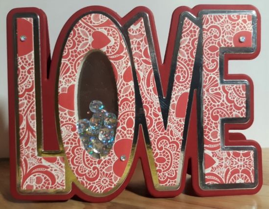 Love is all around 2
LOVE Fold It Card with shaker in the "O" using holographic sequins.  Red, silver mirror and patterned paper layered, , acrylic gems, to decorate
Keywords: LOVE