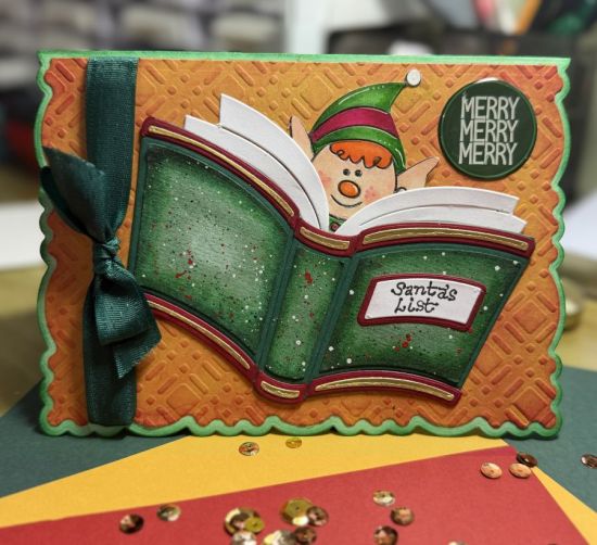 Santa's List 
An open book with an elf
I used: open book fold-it, elves2stamp, plaid stencil (used for embossing)
Keywords: Christmas book elf
