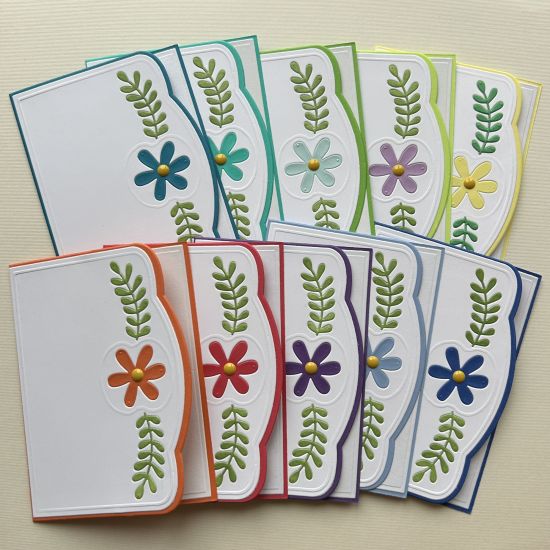 Mini A1 Elegant Edge
I made a rainbow of 10, box set of cards, I ink pounced the leaves to make them green and inlaid them back into the white panel, I die cut all the flowers in the same colour as the card bases so they would match and inlaid them back in, I added yellow enamel dots to the centre of each flower�.

Keywords: Elegant Edge Cardbase